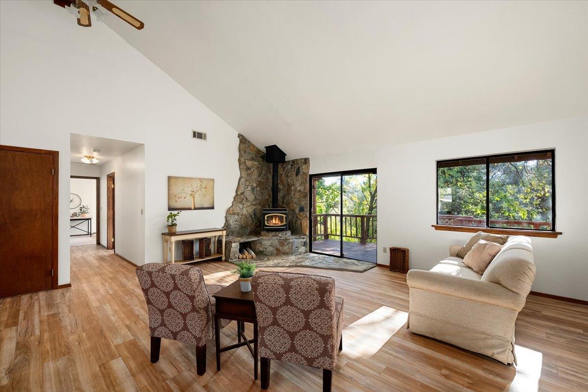 155 Pinewood Way Auburn, CA 95602 - Photo 32 of 92 a living room with furniture a fireplace and a large window