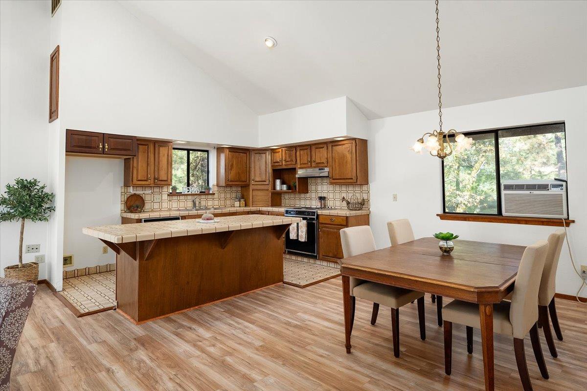 155 Pinewood Way Auburn, CA 95602 - Photo 35 of 92 a kitchen with a table chairs sink and cabinets