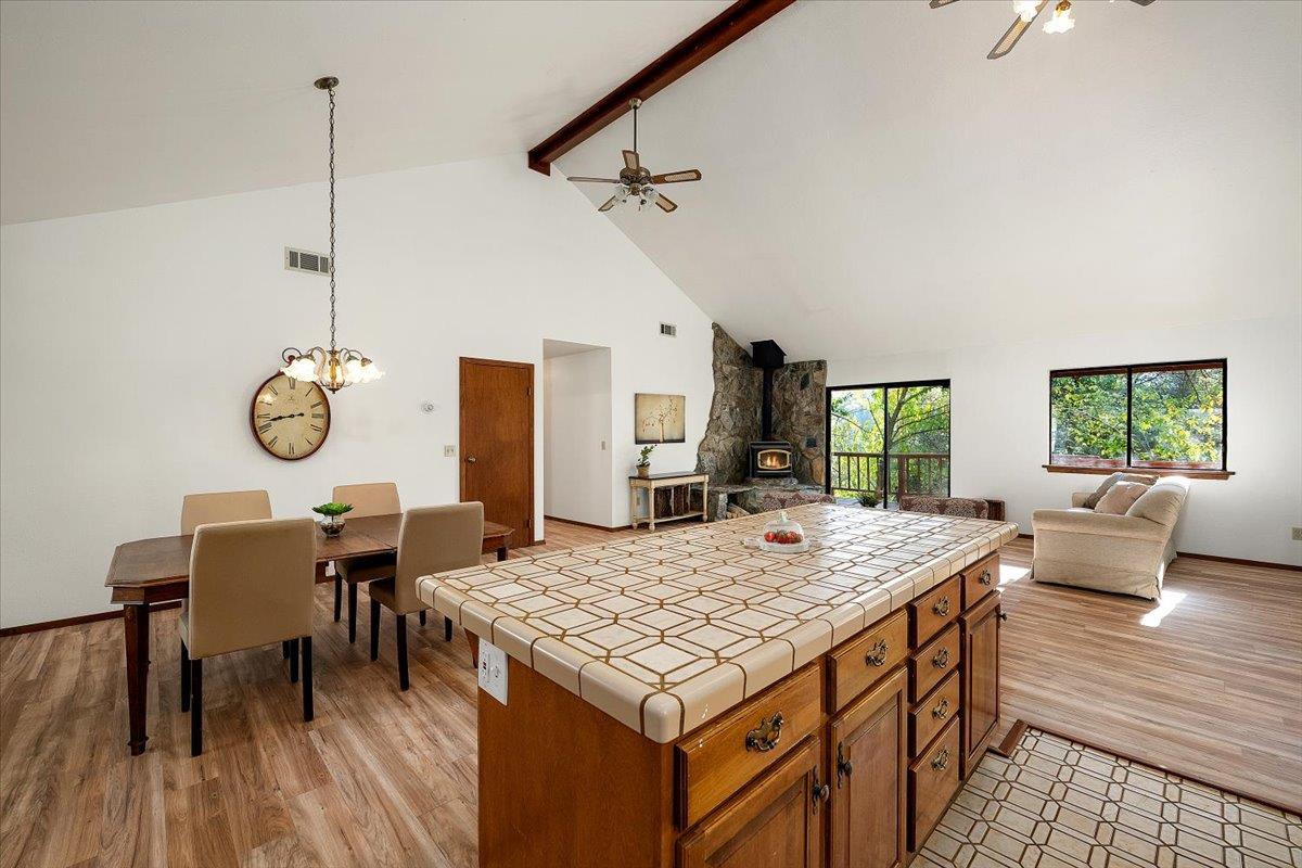 155 Pinewood Way Auburn, CA 95602 - Photo 37 of 92 a living room with dining table furniture and a wooden floor