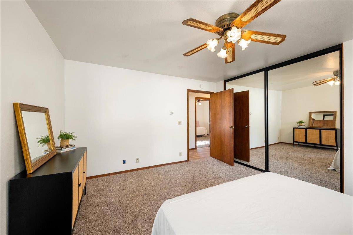 155 Pinewood Way Auburn, CA 95602 - Photo 47 of 92 a bedroom with a bed and a chandelier