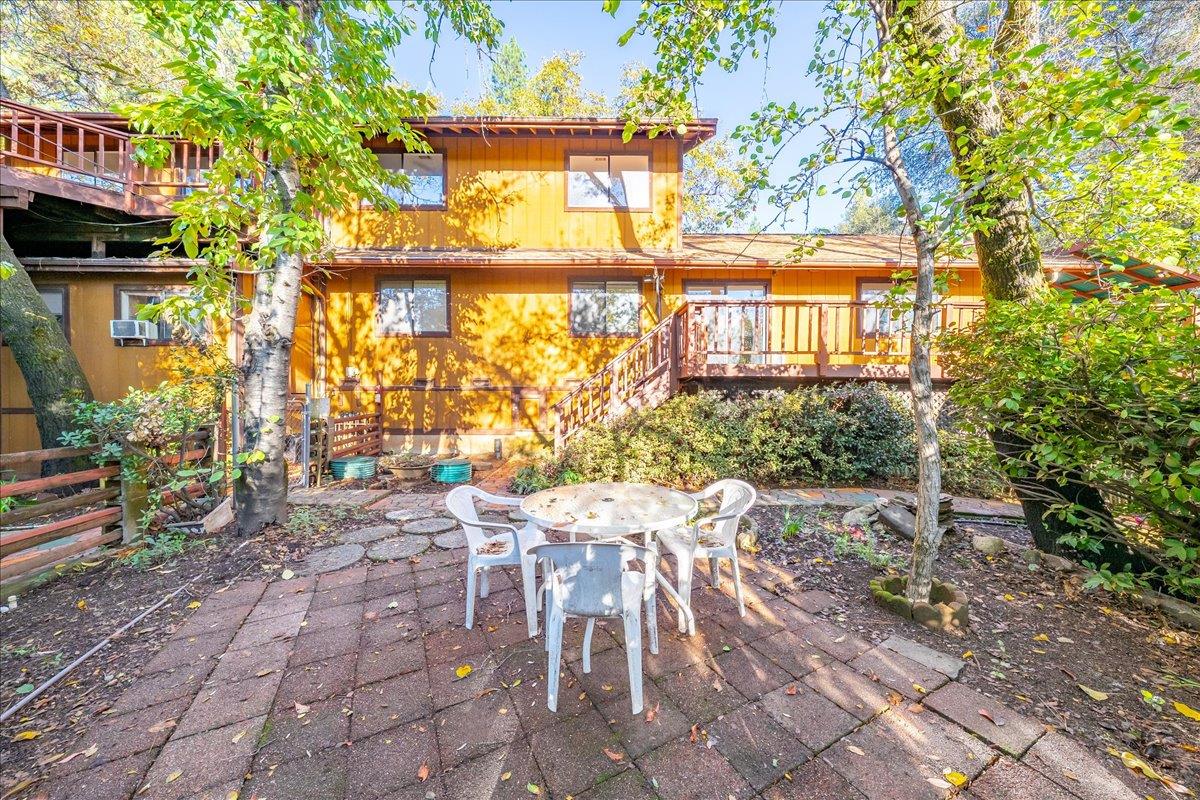 155 Pinewood Way Auburn, CA 95602 - Photo 63 of 92 a view of a chairs and table in a backyard