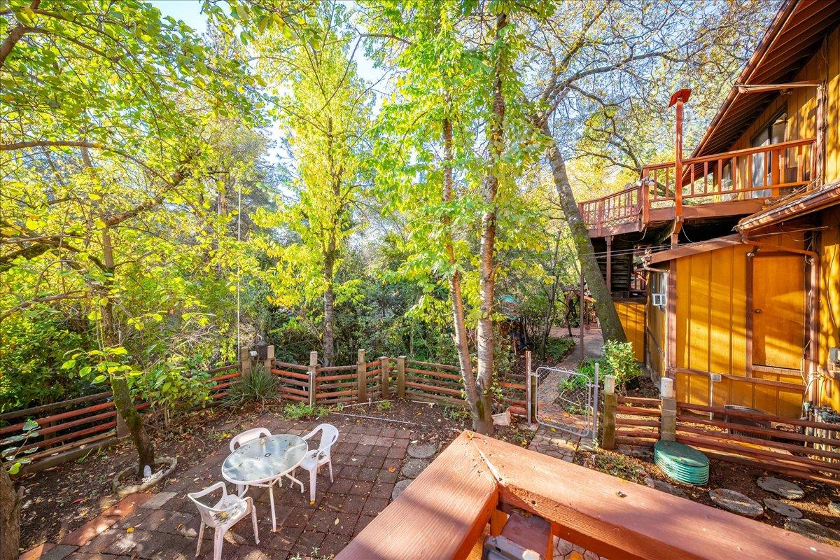 155 Pinewood Way Auburn, CA 95602 - Photo 64 of 92 a view of a patio with table and chairs and potted plants