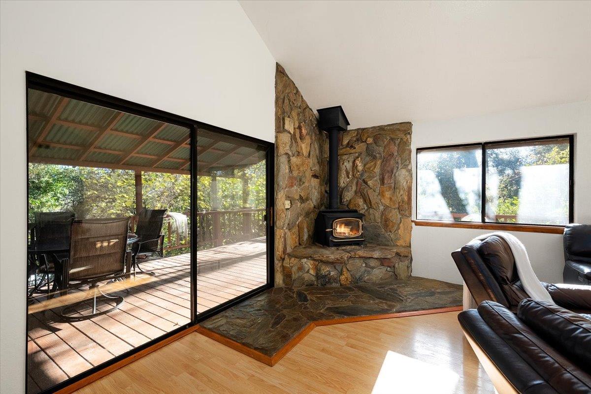 155 Pinewood Way Auburn, CA 95602 - Photo 10 of 92 a living room with furniture tv and a floor to ceiling window
