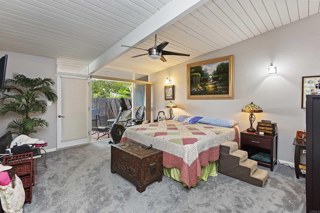 1387 Hygeia Avenue Encinitas, CA 92024 - Photo 11 of 45 a spacious bedroom with a bed a table and potted plants