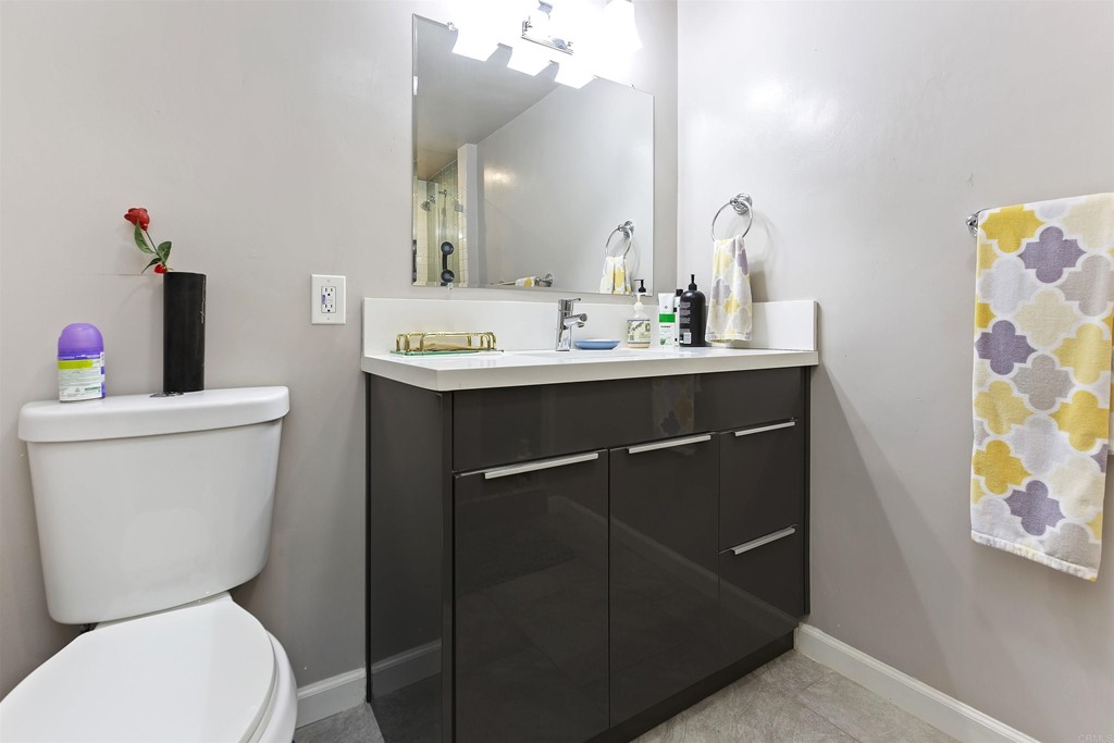 1387 Hygeia Avenue Encinitas, CA 92024 - Photo 15 of 45 a bathroom with a toilet sink and mirror