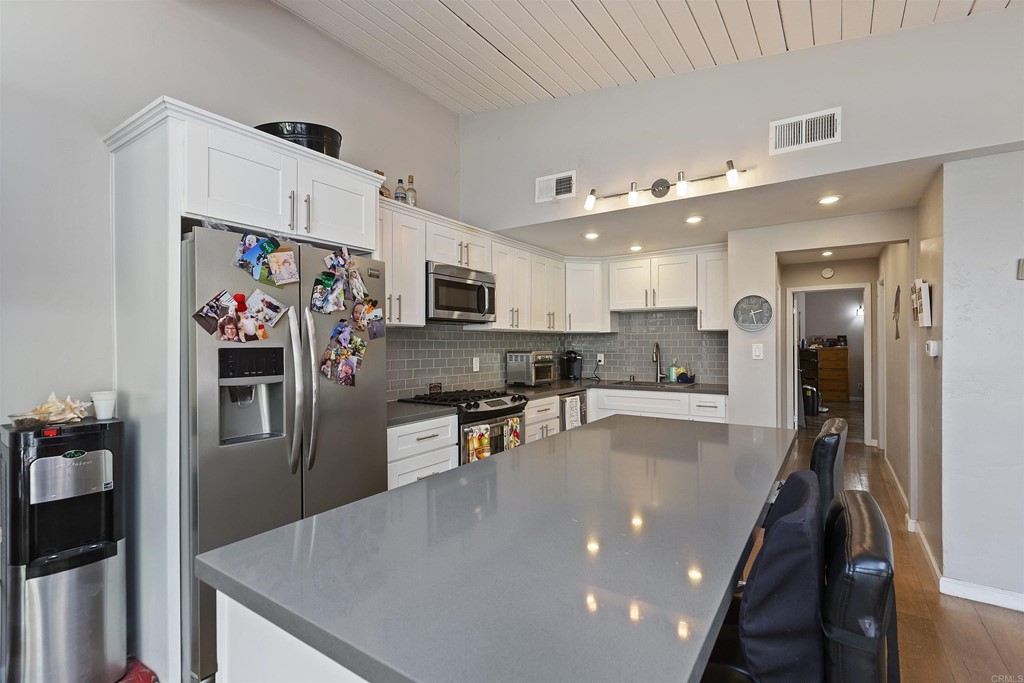 1387 Hygeia Avenue Encinitas, CA 92024 - Photo 19 of 45 a kitchen with stainless steel appliances a refrigerator sink and stove