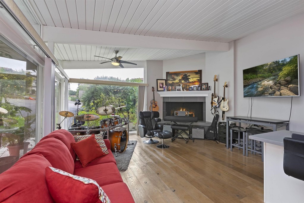 1387 Hygeia Avenue Encinitas, CA 92024 - Photo 22 of 45 a living room with furniture a fireplace and a flat screen tv