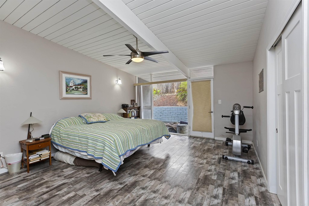 1387 Hygeia Avenue Encinitas, CA 92024 - Photo 26 of 45 a bedroom with a bed and a chandelier