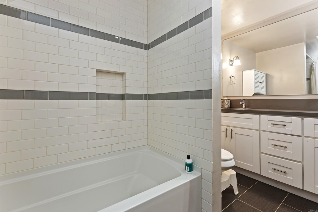 1387 Hygeia Avenue Encinitas, CA 92024 - Photo 28 of 45 a bathroom with a granite countertop sink a toilet and bathtub