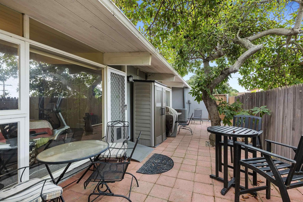 1387 Hygeia Avenue Encinitas, CA 92024 - Photo 29 of 45 a view of a patio with table and chairs and potted plants with large tree