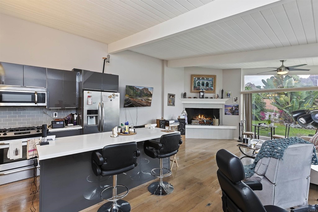 1387 Hygeia Avenue Encinitas, CA 92024 - Photo 7 of 45 a kitchen with a table chairs refrigerator and cabinets