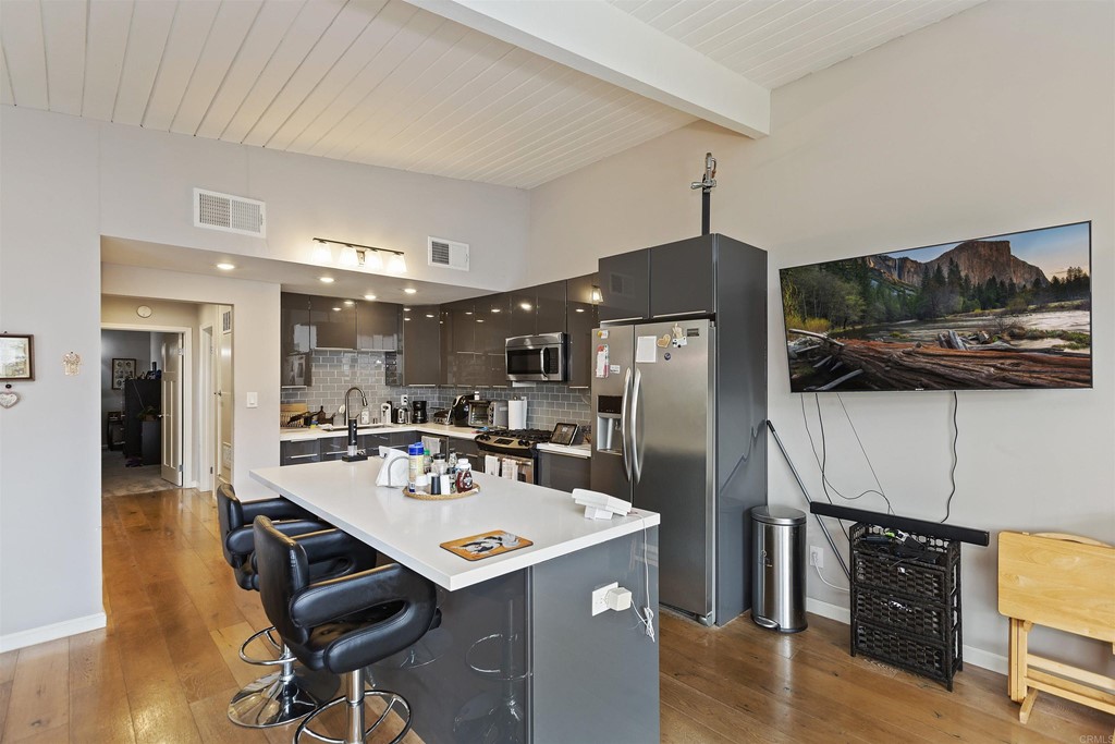 1387 Hygeia Avenue Encinitas, CA 92024 - Photo 10 of 45 a kitchen with stainless steel appliances a dining table chairs and wooden floor