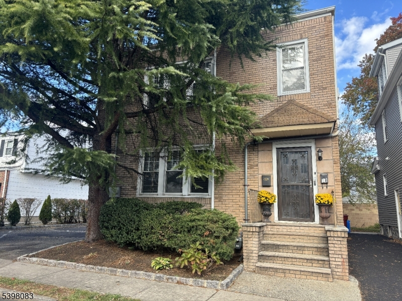 front view of a house with a tree