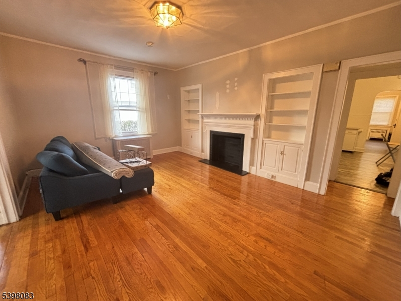 18 Laura Avenue, Unit 1 Nutley, NJ 07110 - Photo 11 of 27 a living room with furniture and a fireplace
