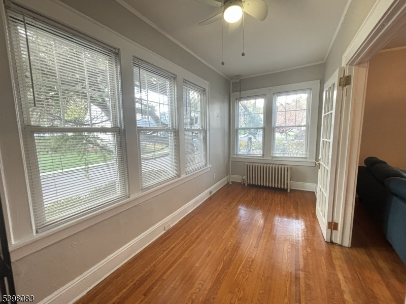18 Laura Avenue, Unit 1 Nutley, NJ 07110 - Photo 13 of 27 a view of an empty room with wooden floor and a window