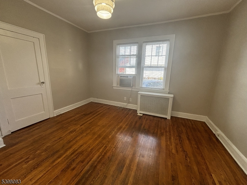 18 Laura Avenue, Unit 1 Nutley, NJ 07110 - Photo 14 of 27 an empty room with wooden floor and windows