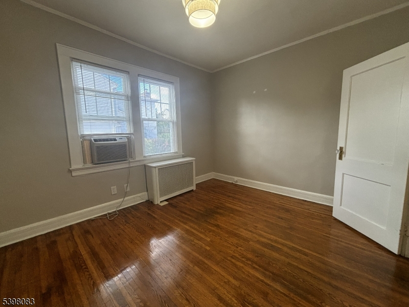 18 Laura Avenue, Unit 1 Nutley, NJ 07110 - Photo 15 of 27 an empty room with wooden floor and windows