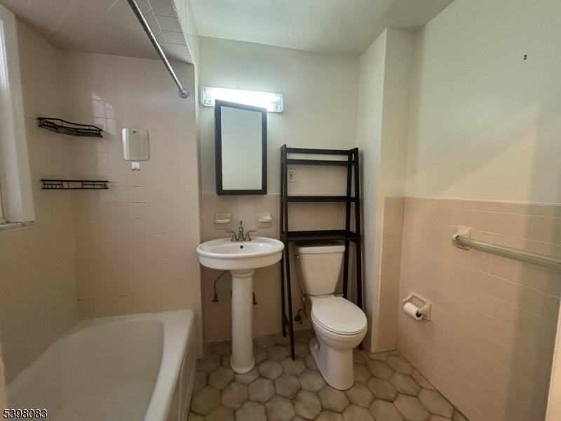 18 Laura Avenue, Unit 1 Nutley, NJ 07110 - Photo 19 of 27 a bathroom with a sink toilet and a mirror