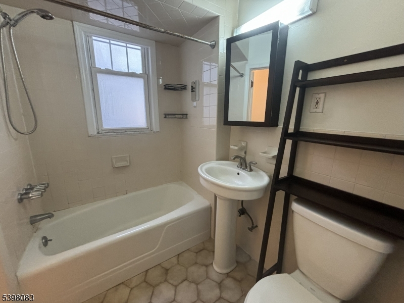 18 Laura Avenue, Unit 1 Nutley, NJ 07110 - Photo 20 of 27 a bathroom with a sink toilet and shower