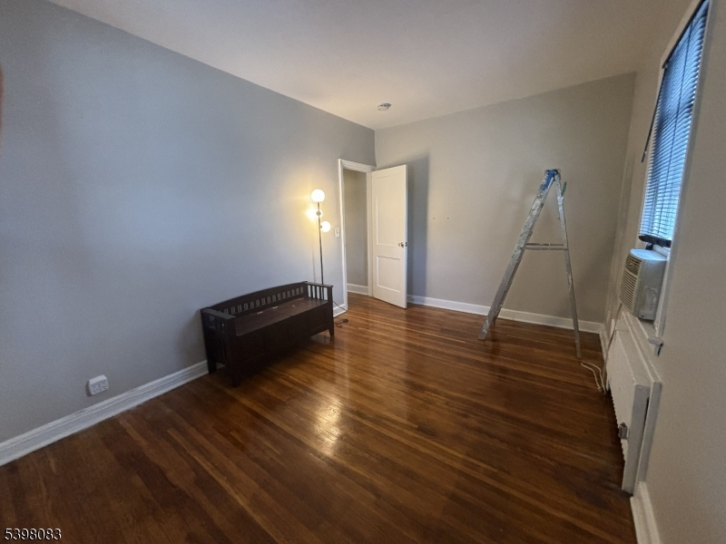 18 Laura Avenue, Unit 1 Nutley, NJ 07110 - Photo 21 of 27 a room with wooden floor and a ceiling fan