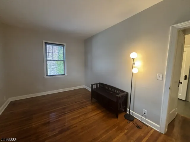 a view of room with window and wooden floor