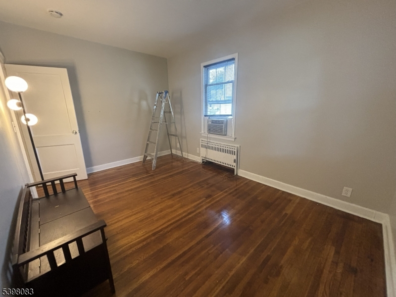 18 Laura Avenue, Unit 1 Nutley, NJ 07110 - Photo 23 of 27 a view of an empty room with wooden floor and a window