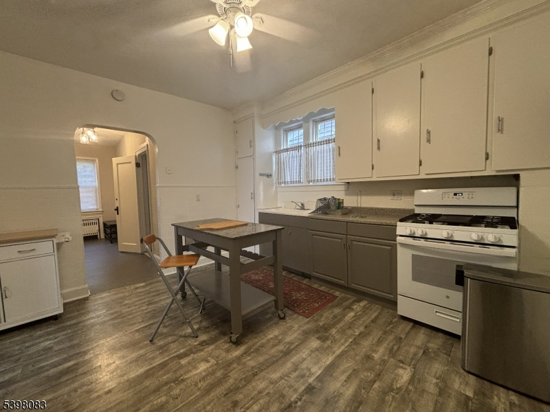 18 Laura Avenue, Unit 1 Nutley, NJ 07110 - Photo 5 of 27 a kitchen with a stove a sink and a refrigerator