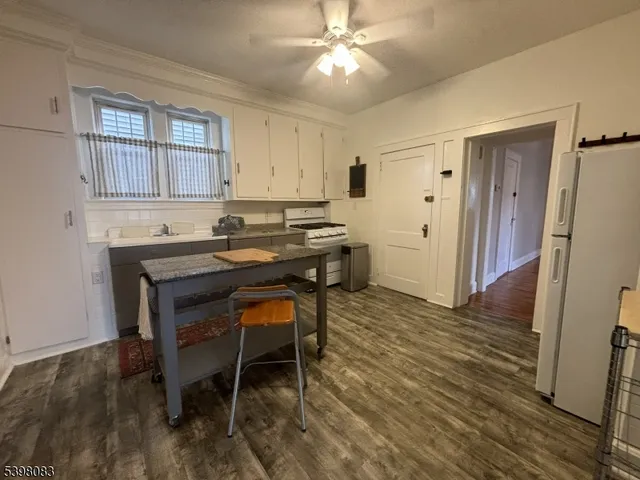 a kitchen with stainless steel appliances granite countertop a sink and a refrigerator