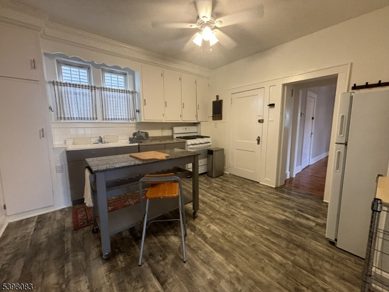 18 Laura Avenue, Unit 1 Nutley, NJ 07110 - Photo 6 of 27 a kitchen with stainless steel appliances granite countertop a sink and a refrigerator