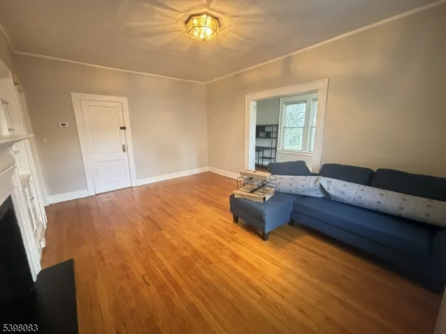 a living room with a couch and a chandelier