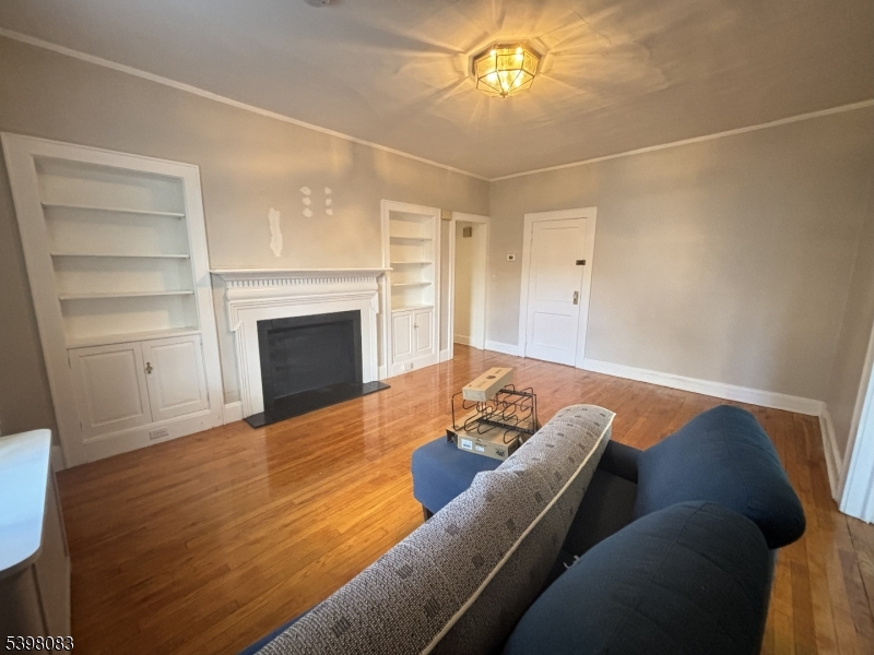 18 Laura Avenue, Unit 1 Nutley, NJ 07110 - Photo 10 of 27 a living room with furniture and a fireplace