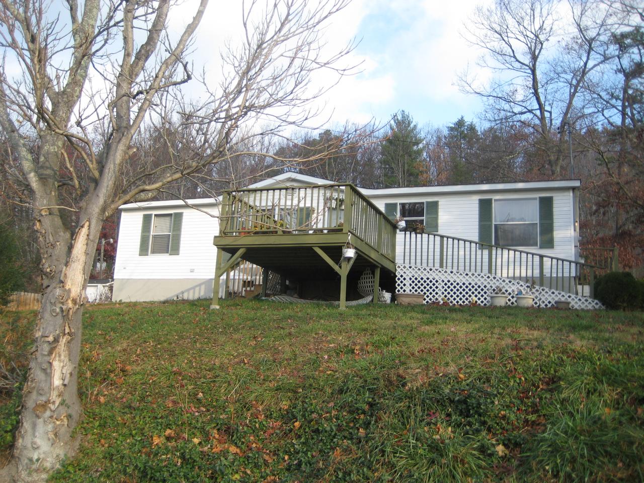 a view of a house with a yard in front of it