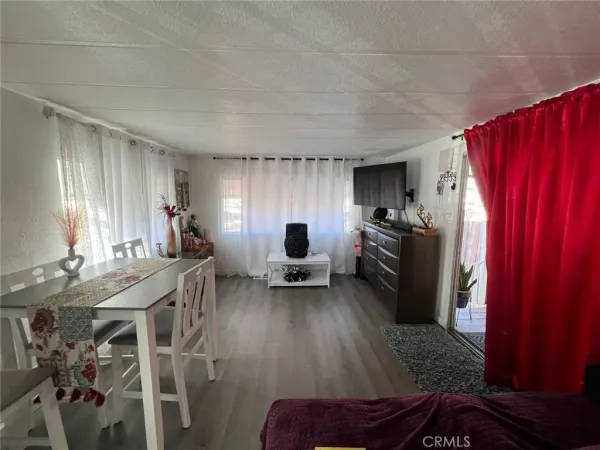 a living room with furniture a dining table and chairs