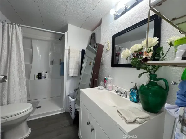 a bathroom with a sink toilet and shower