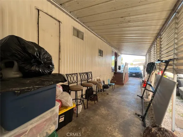 a view of a chairs and table in the balcony