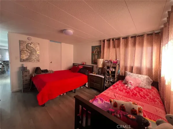 a bedroom with bed and a night stand