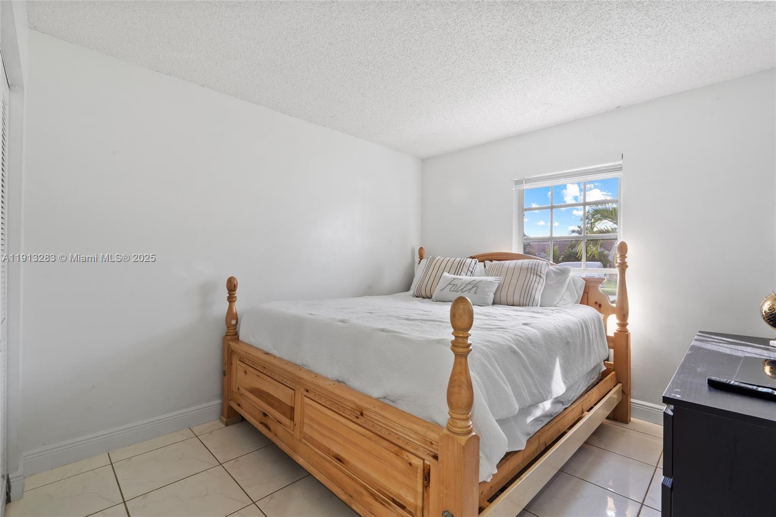 12535 Southwest 219th Street Miami, FL 33170 - Photo 16 of 31 a bed room with a bed and a window