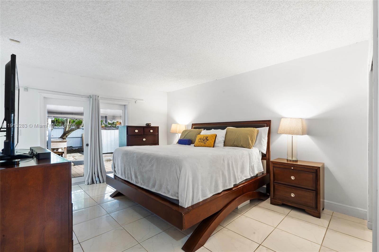 12535 Southwest 219th Street Miami, FL 33170 - Photo 17 of 31 a bedroom with a bed and lamp