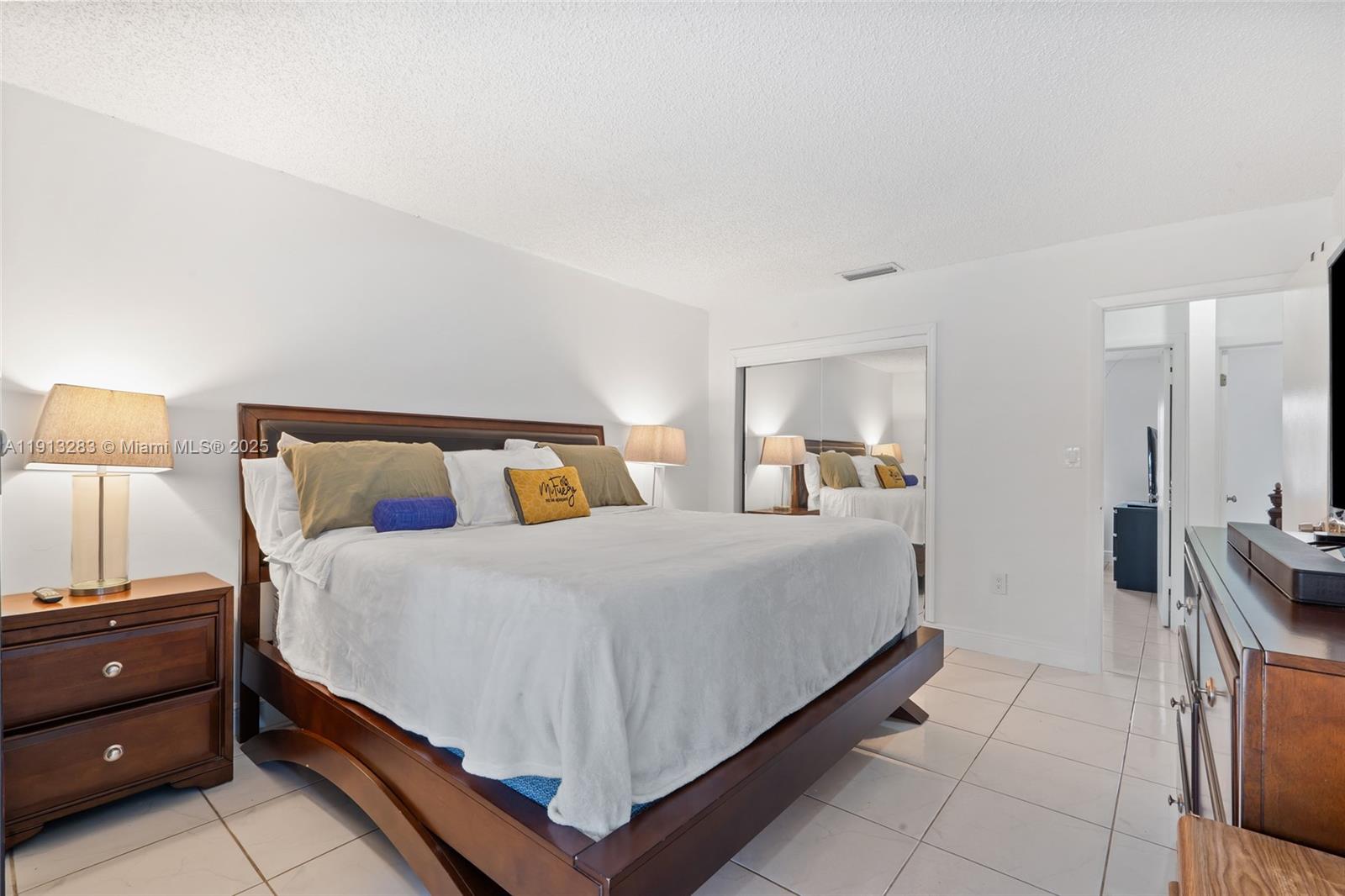 12535 Southwest 219th Street Miami, FL 33170 - Photo 18 of 31 a bedroom with a bed and lamp on dresser