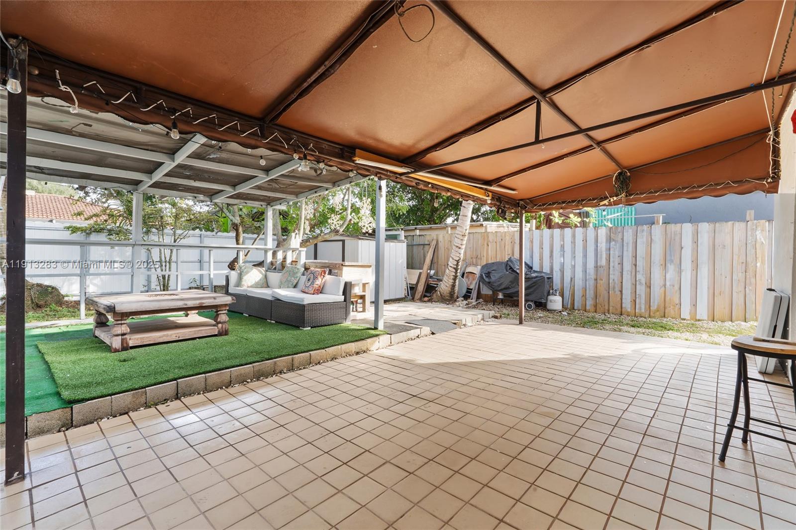 12535 Southwest 219th Street Miami, FL 33170 - Photo 25 of 31 a backyard of a house with barbeque oven table and chairs