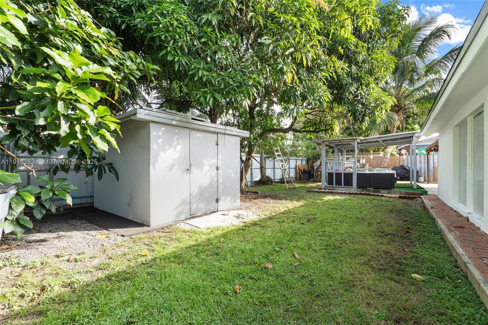 12535 Southwest 219th Street Miami, FL 33170 - Photo 28 of 31 a backyard of a house with plants and large tree