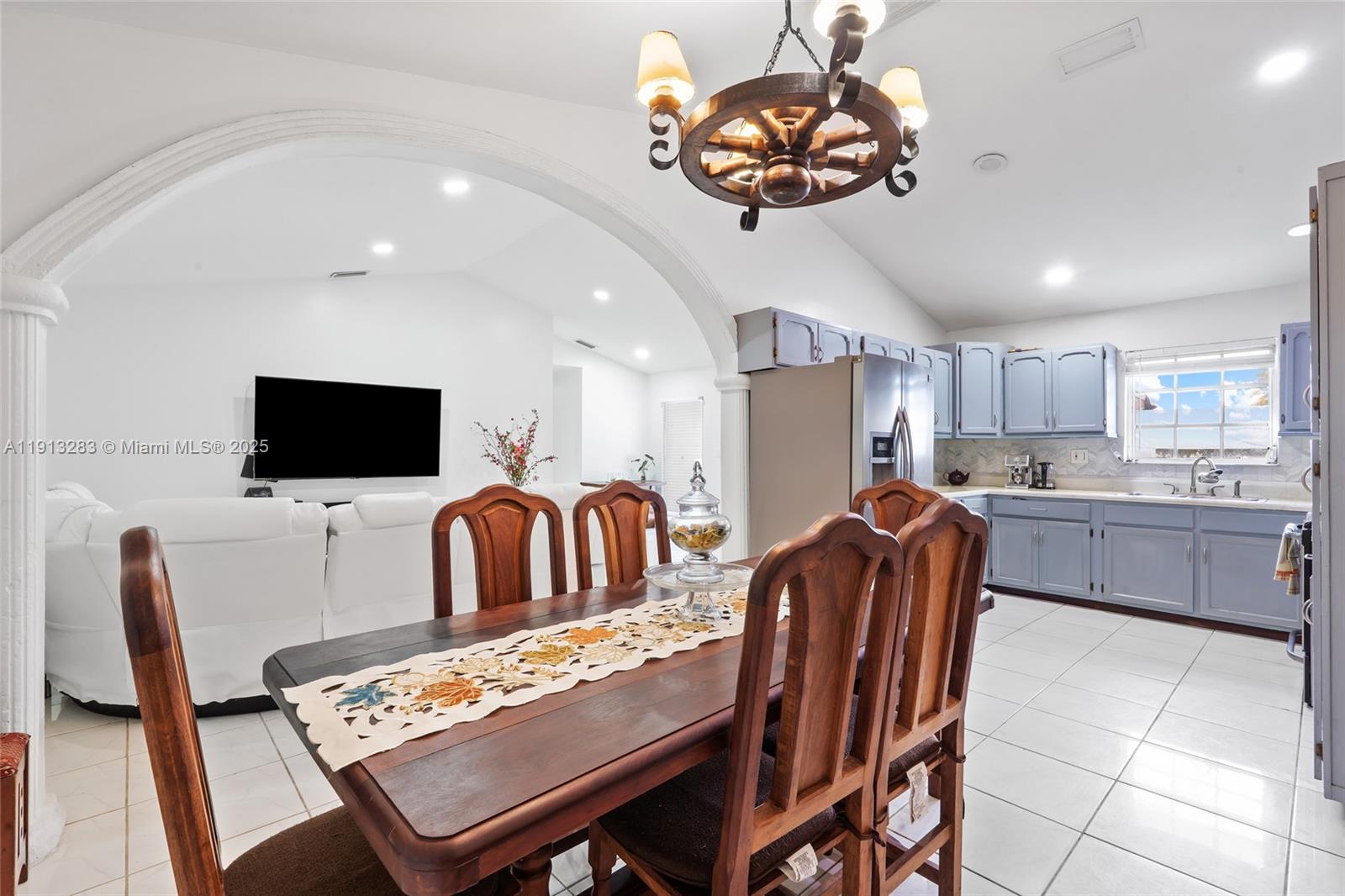 12535 Southwest 219th Street Miami, FL 33170 - Photo 8 of 31 a living room with furniture a flat screen tv and kitchen view