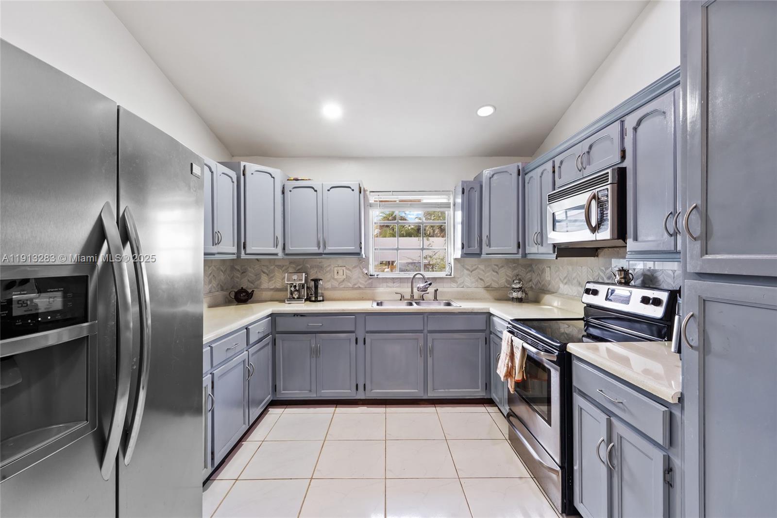 12535 Southwest 219th Street Miami, FL 33170 - Photo 9 of 31 a kitchen with stainless steel appliances granite countertop a sink stove refrigerator and cabinets