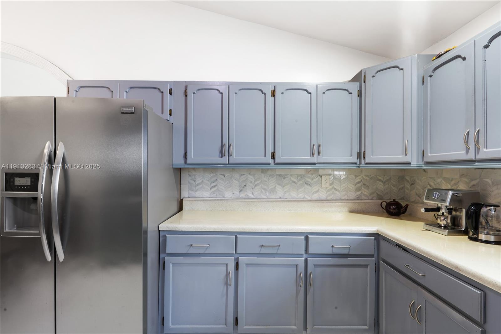 12535 Southwest 219th Street Miami, FL 33170 - Photo 10 of 31 a kitchen with a refrigerator and cabinets