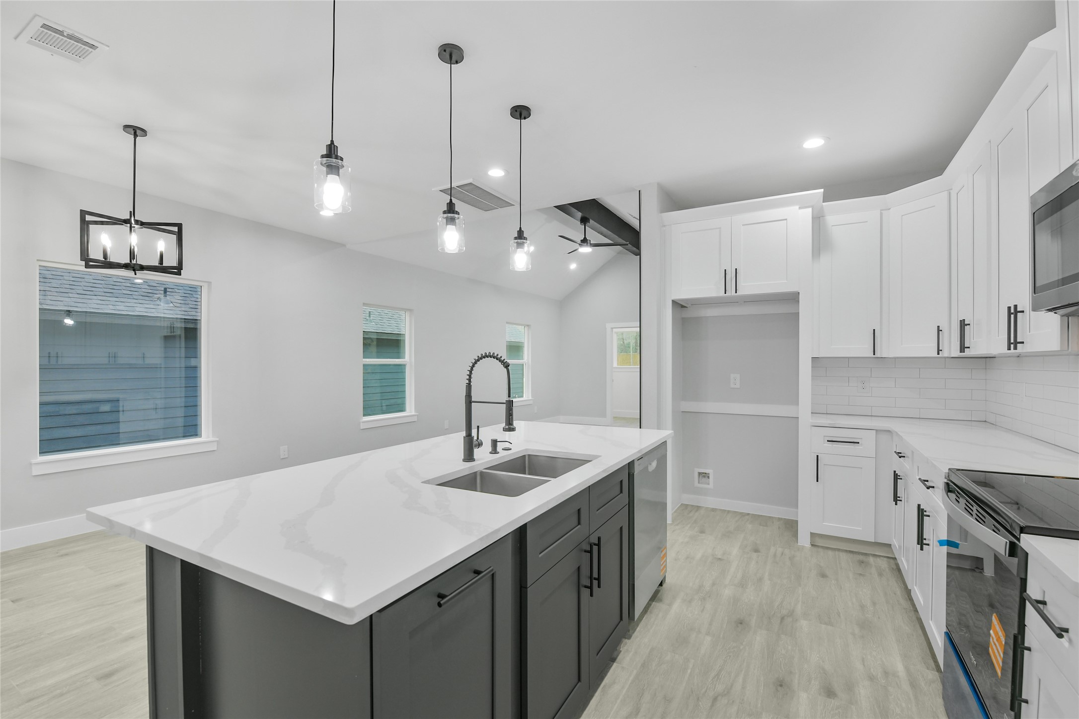 15113 Austin Road Willis, TX 77378 - Photo 12 of 37 a kitchen with kitchen island a sink appliances and a counter top space