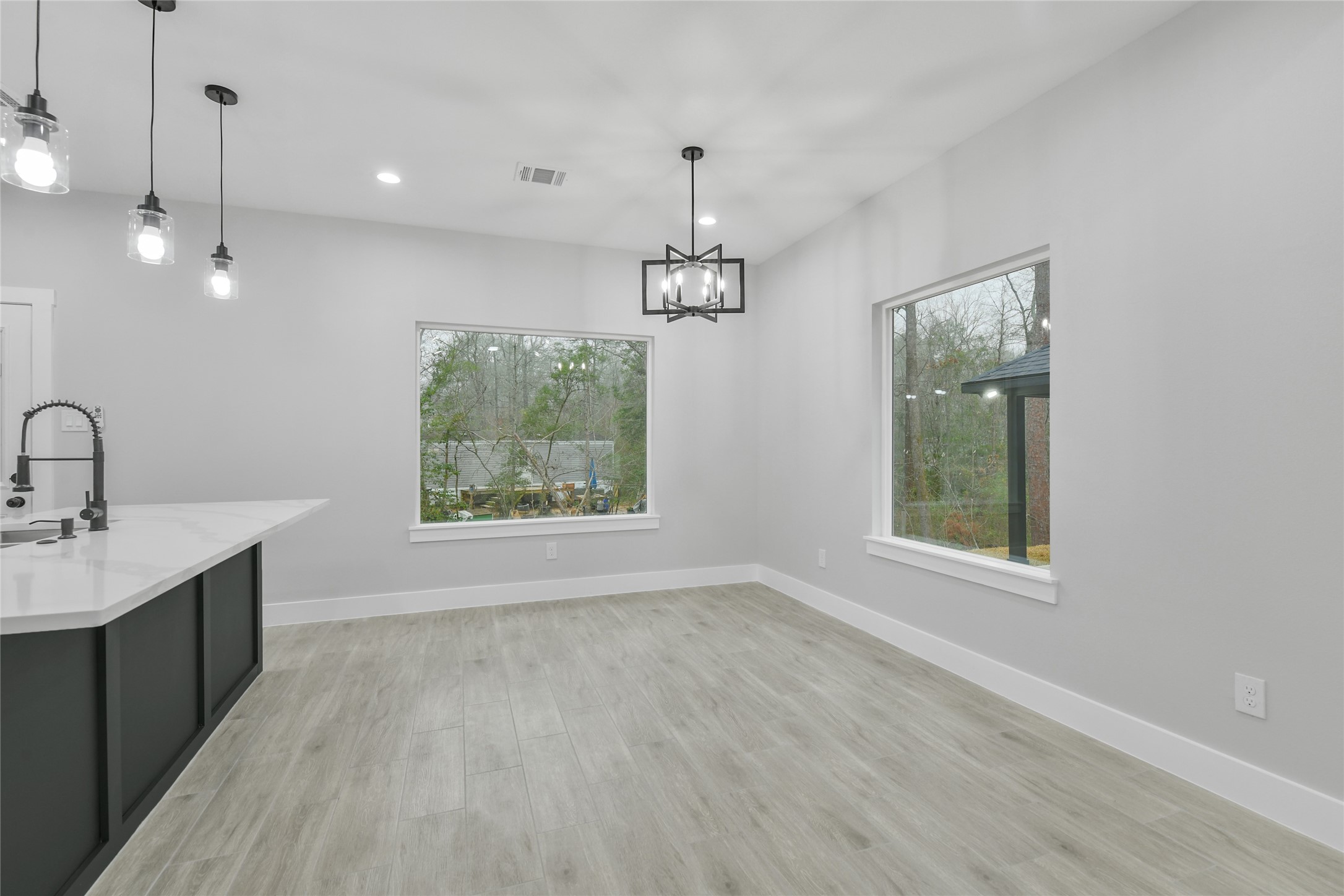 15113 Austin Road Willis, TX 77378 - Photo 16 of 37 a view of a kitchen with a sink wooden floor and a window