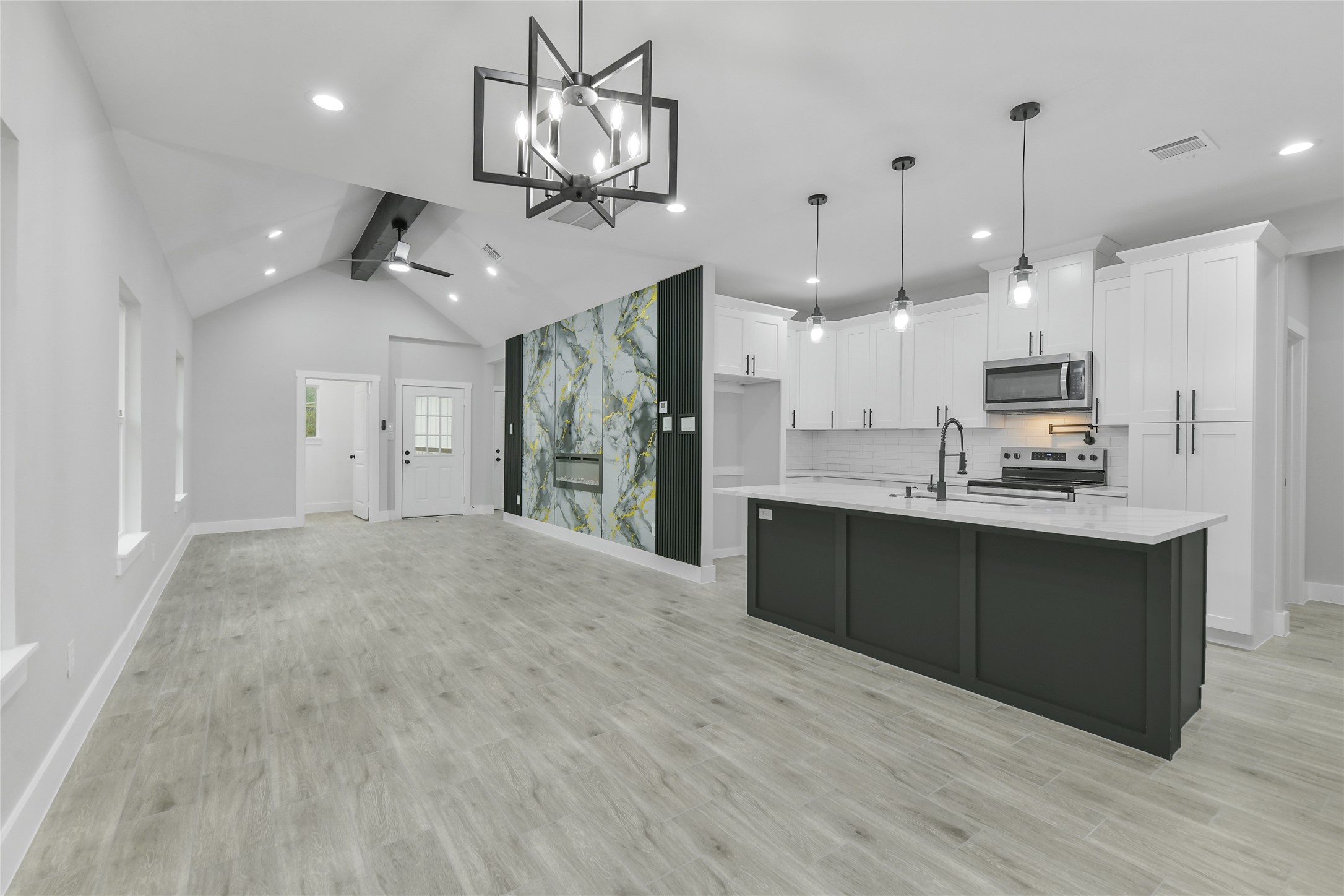 15113 Austin Road Willis, TX 77378 - Photo 17 of 37 a large kitchen with granite countertop a large counter top appliances and cabinets