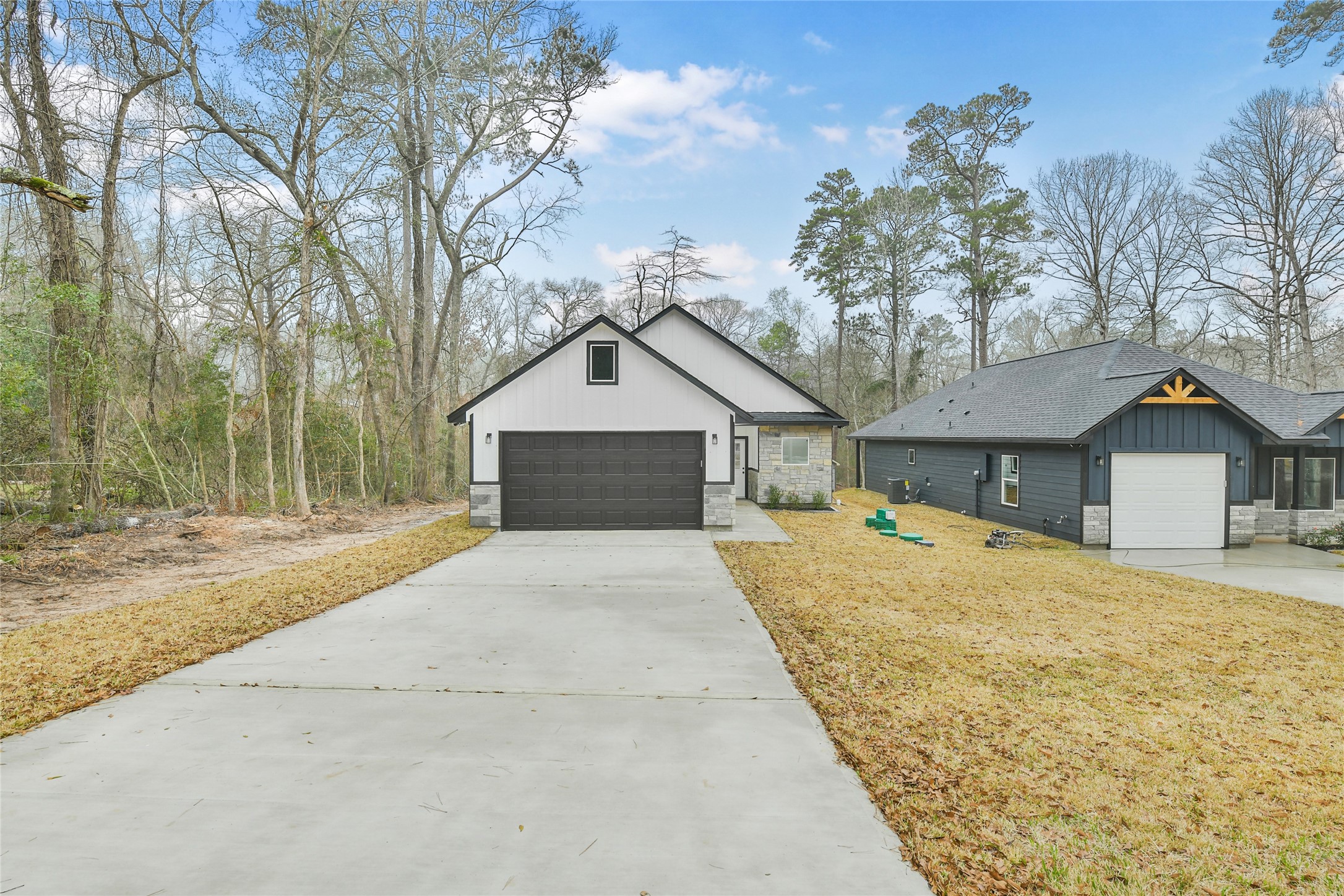 15113 Austin Road Willis, TX 77378 - Photo 2 of 37 a front view of a house with a yard and garage