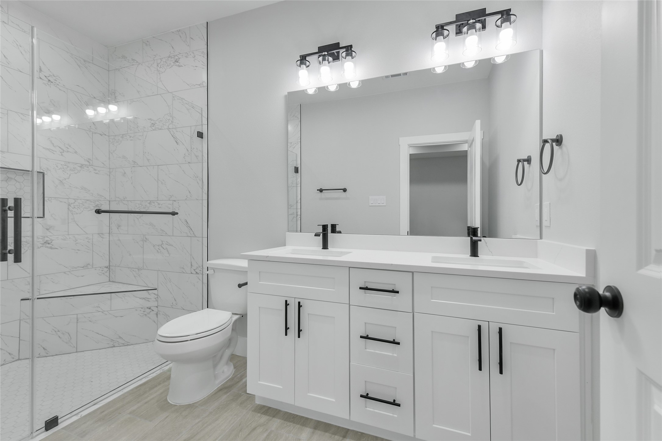 15113 Austin Road Willis, TX 77378 - Photo 21 of 37 a spacious bathroom with a toilet a sink a mirror and shower