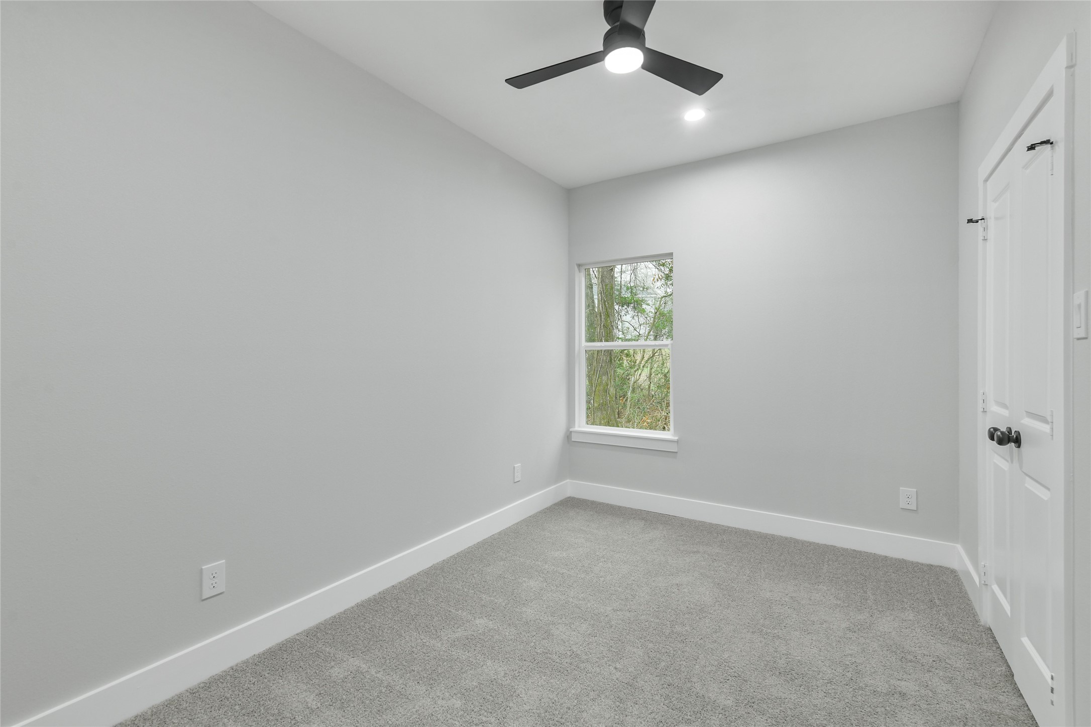 15113 Austin Road Willis, TX 77378 - Photo 24 of 37 an empty room with a window and a fan
